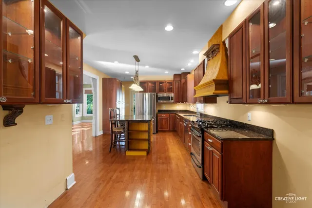a kitchen with a table chairs sink and cabinets