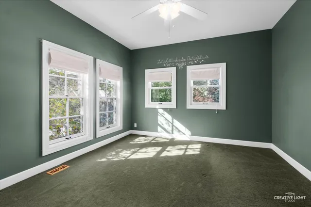 a view of room with hardwood floor and ceiling fan
