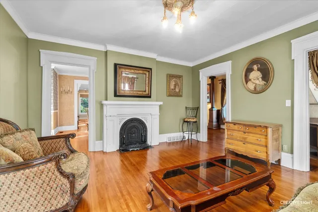 a view of a hallway with wooden floor and furniture