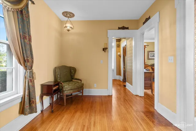 a room with wooden floor and chandelier