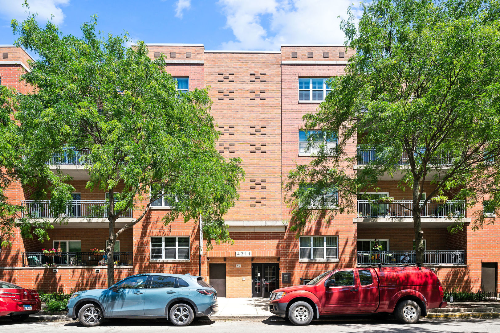4311 North Sheridan Road, Unit 303 Chicago, IL 60613 - Photo 1 of 17 a cars parked in front of a building