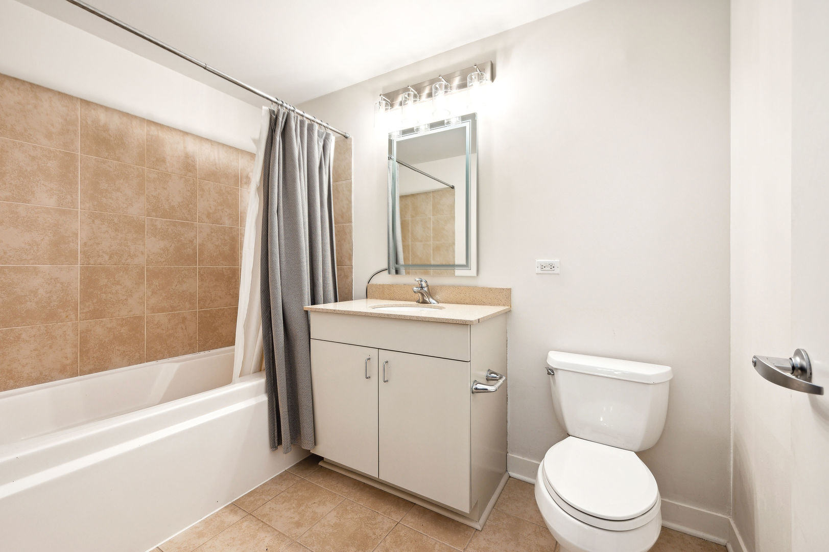 4311 North Sheridan Road, Unit 303 Chicago, IL 60613 - Photo 13 of 17 a bathroom with a sink a toilet and shower