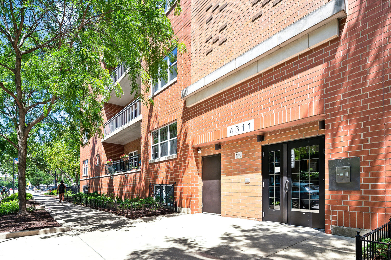 4311 North Sheridan Road, Unit 303 Chicago, IL 60613 - Photo 2 of 17 a view of a brick house with many windows next to a road
