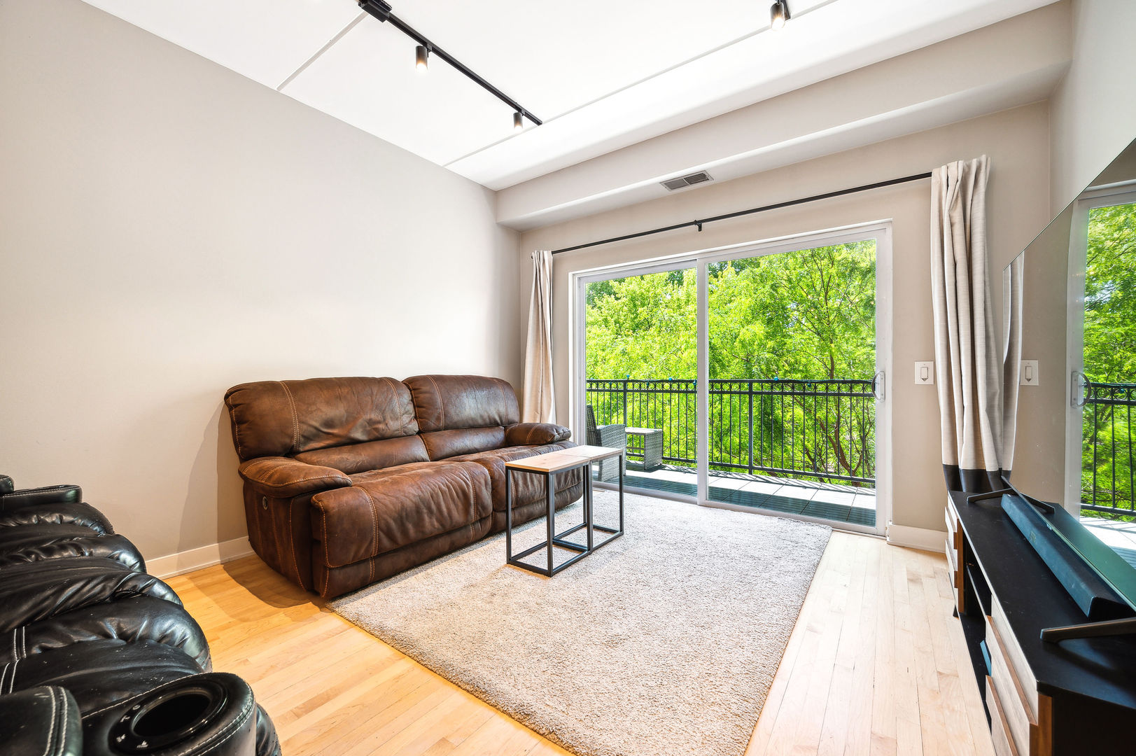 4311 North Sheridan Road, Unit 303 Chicago, IL 60613 - Photo 3 of 17 a living room with furniture and a large window