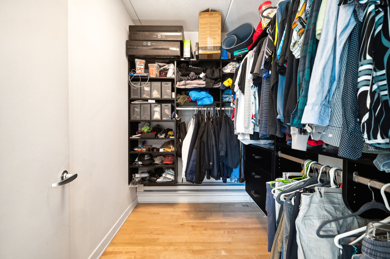 4311 North Sheridan Road, Unit 303 Chicago, IL 60613 - Photo 10 of 17 a view of walk in closet with clothes and shoes