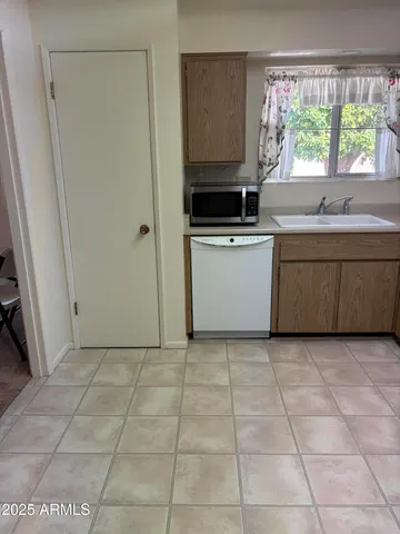 a kitchen with a stove a sink and a microwave