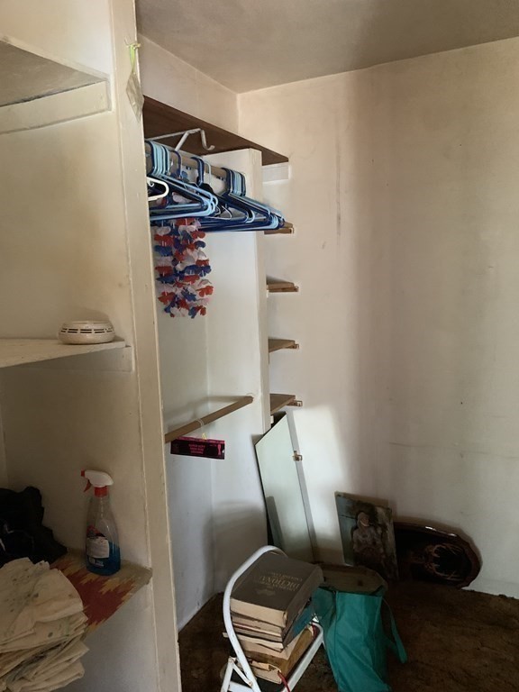 39 Evergreen Road Norton, MA 02766 - Photo 17 of 25 a view of storage and utility room with racks on the wall