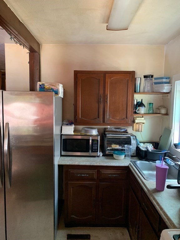 39 Evergreen Road Norton, MA 02766 - Photo 7 of 25 a kitchen with a refrigerator and a sink