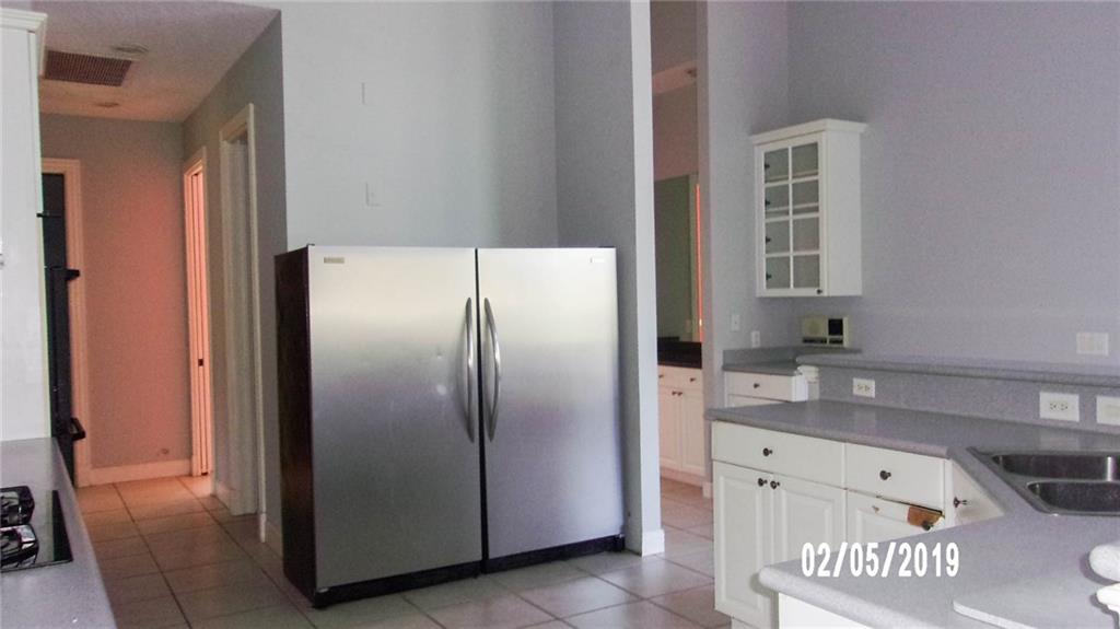 18217 Southeast Ridgeview Drive Jupiter, FL 33469 - Photo 7 of 18 a kitchen with stainless steel appliances granite countertop a refrigerator and a sink