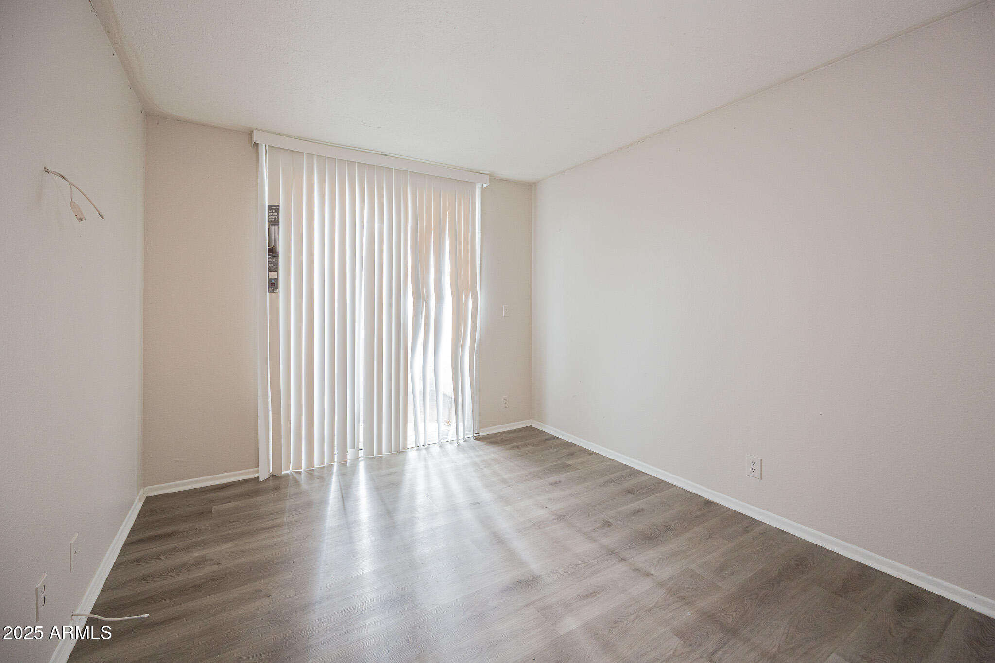 2352 East Broadway Road, Unit A Mesa, AZ 85204 - Photo 10 of 14 a view of an empty room with wooden floor