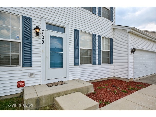 729 Periwinkle Lane Aurora, IL 60504 - Photo 15 of 15 a view of a house with a door and a window
