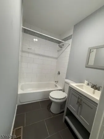 a bathroom with a sink toilet a mirror and shower