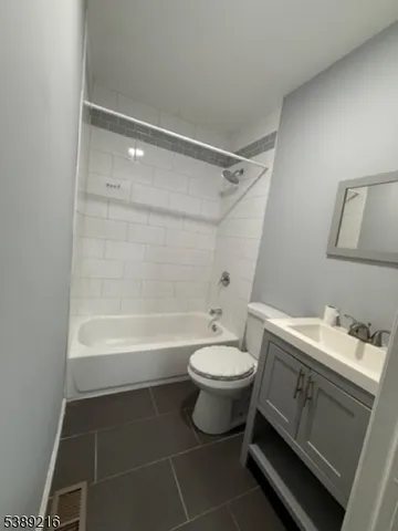 a bathroom with a sink toilet a mirror and shower