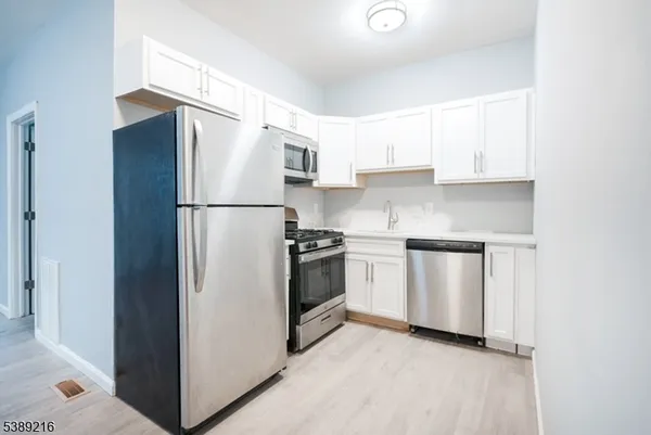 a white refrigerator freezer sitting in a kitchen