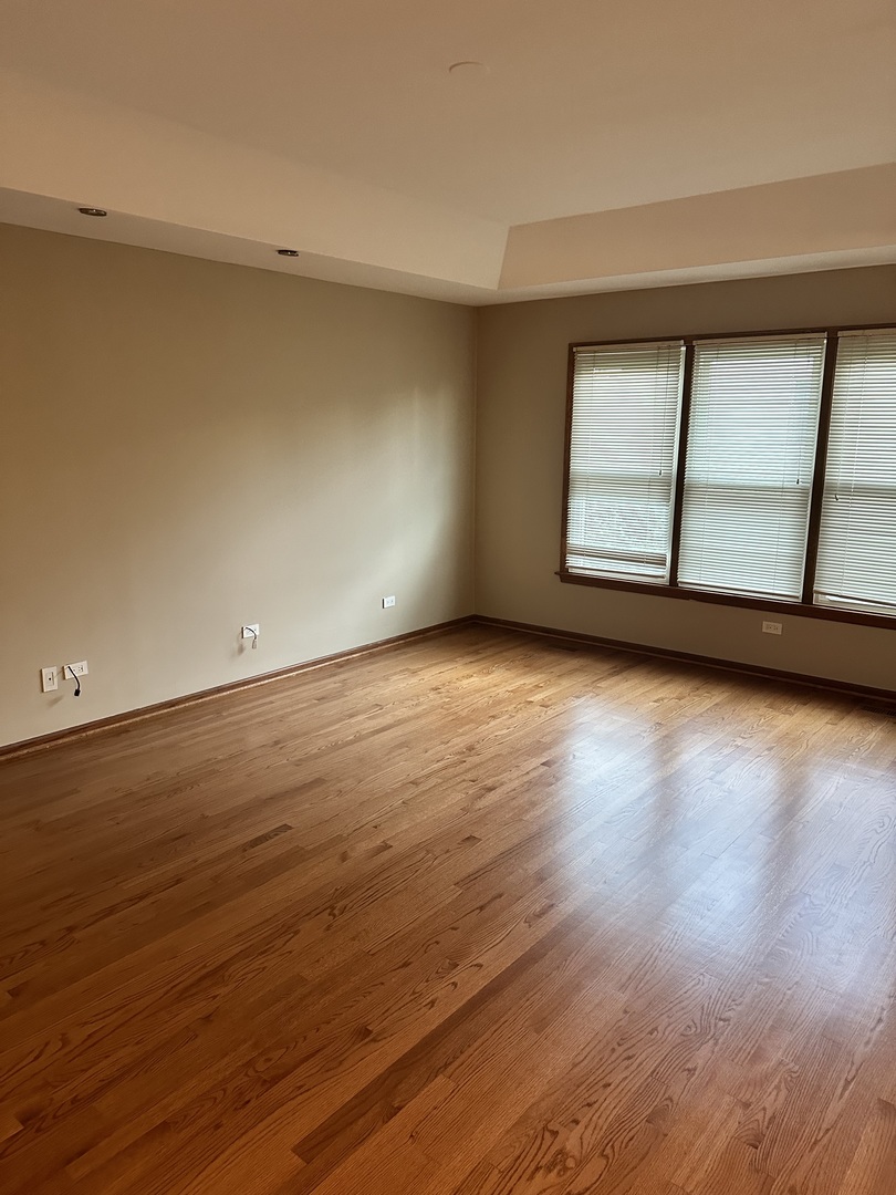 1592 Wakefield Court Mundelein, IL 60060 - Photo 11 of 25 a view of an empty room with wooden floor and a window