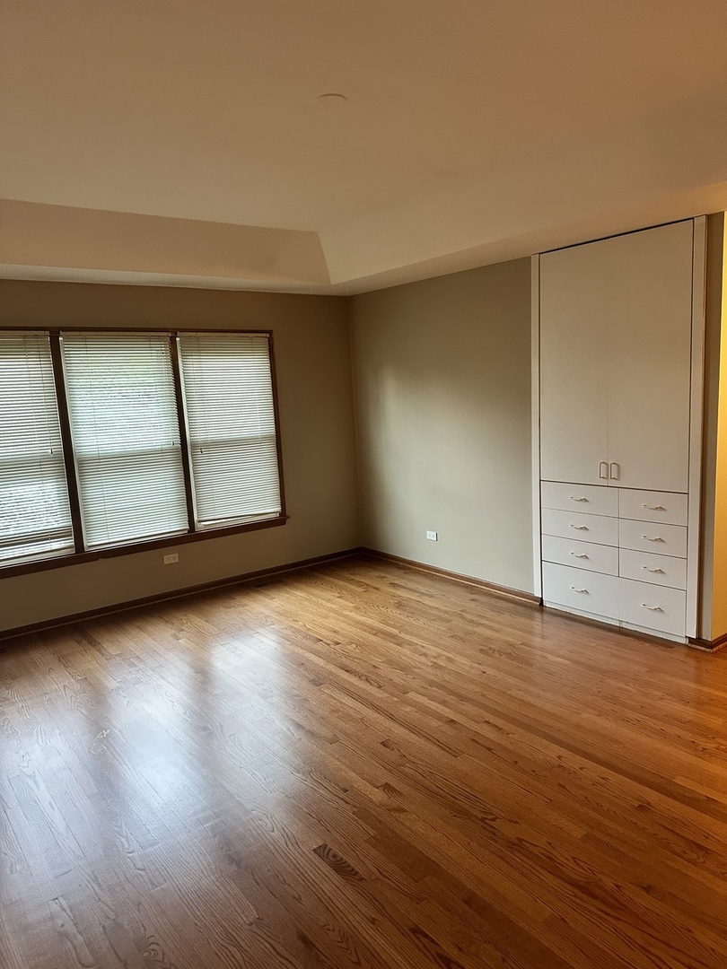 1592 Wakefield Court Mundelein, IL 60060 - Photo 12 of 25 an empty room with wooden floor and windows