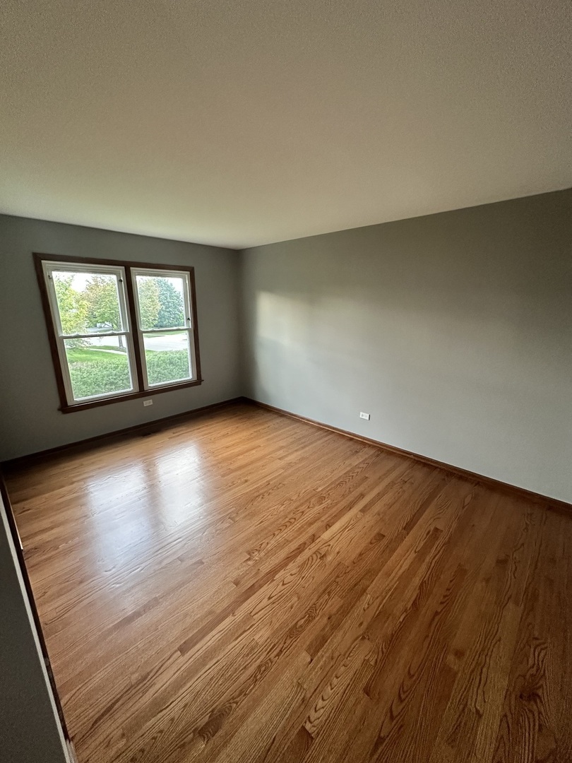 1592 Wakefield Court Mundelein, IL 60060 - Photo 18 of 25 an empty room with wooden floor and windows