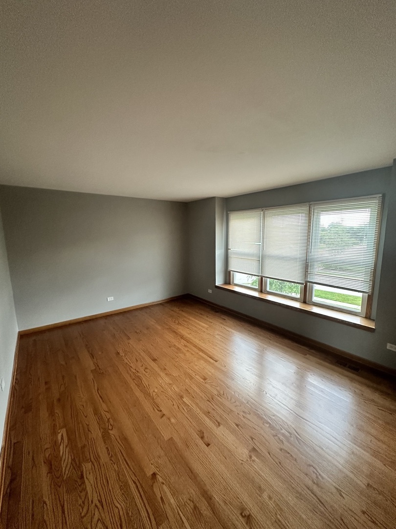 1592 Wakefield Court Mundelein, IL 60060 - Photo 19 of 25 an empty room with wooden floor and windows