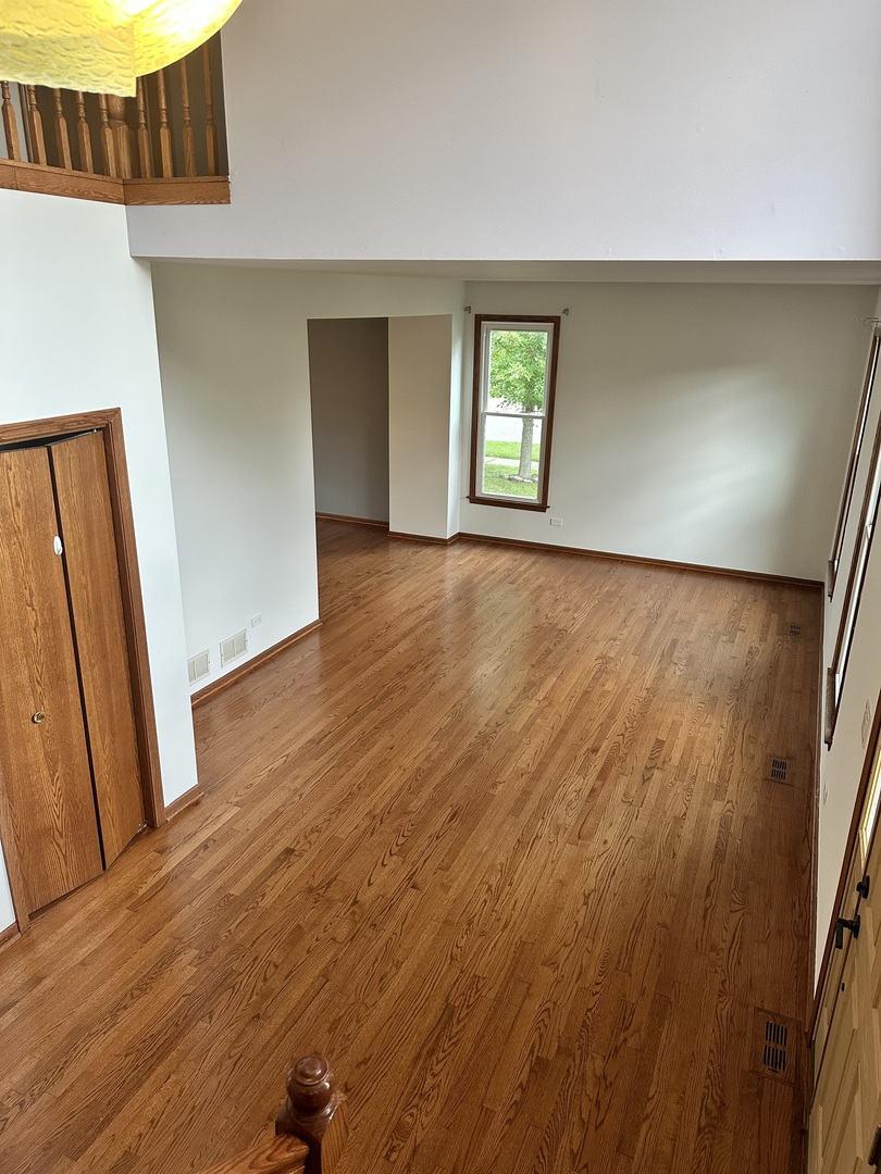 1592 Wakefield Court Mundelein, IL 60060 - Photo 4 of 25 an empty room with wooden floor and windows