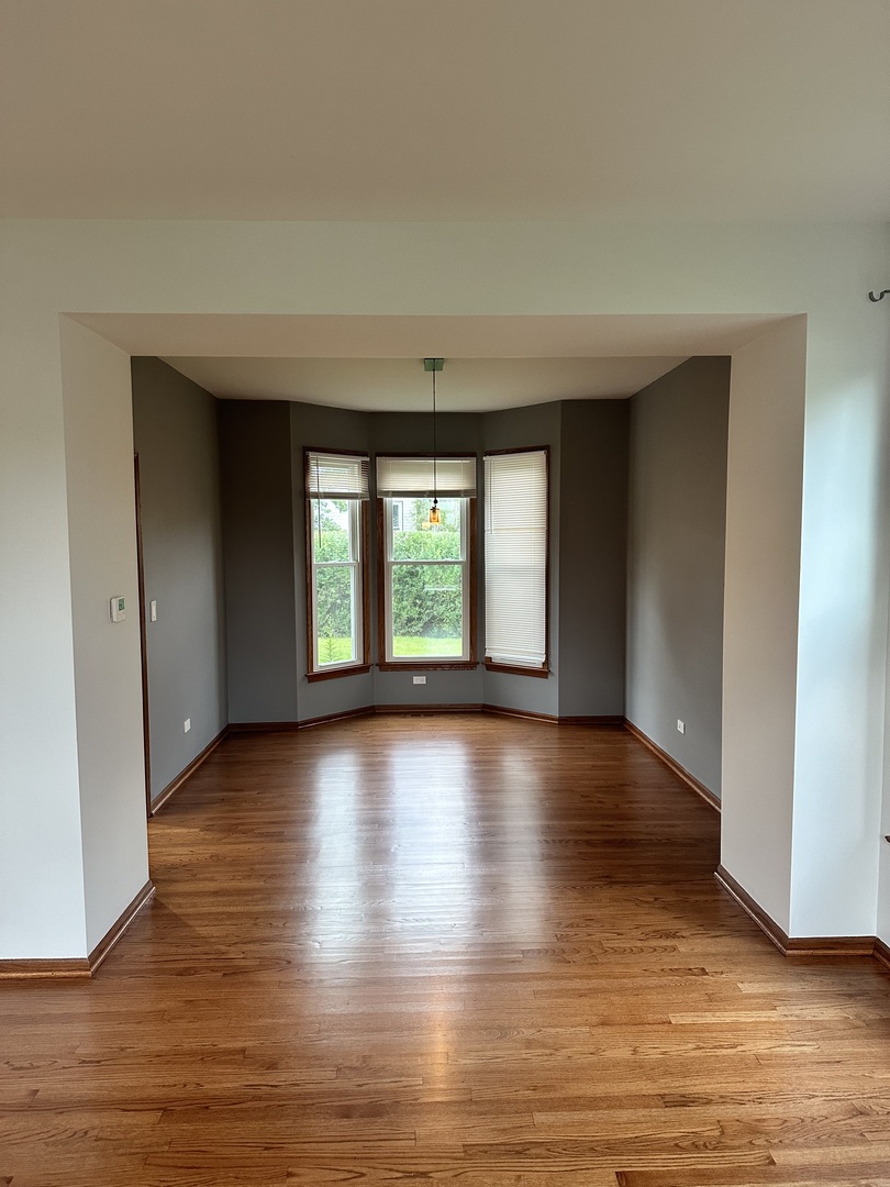1592 Wakefield Court Mundelein, IL 60060 - Photo 5 of 25 wooden floor in an empty room with a window