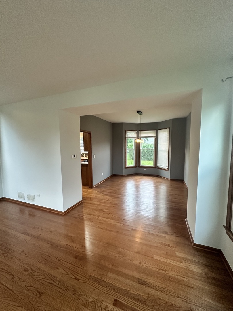 1592 Wakefield Court Mundelein, IL 60060 - Photo 6 of 25 a view of livingroom with hardwood floor and window