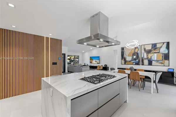 a kitchen with a stove a table and chairs