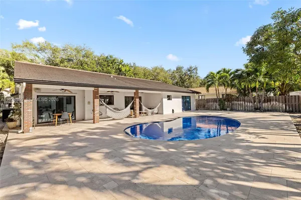 a view of a house with pool and porch