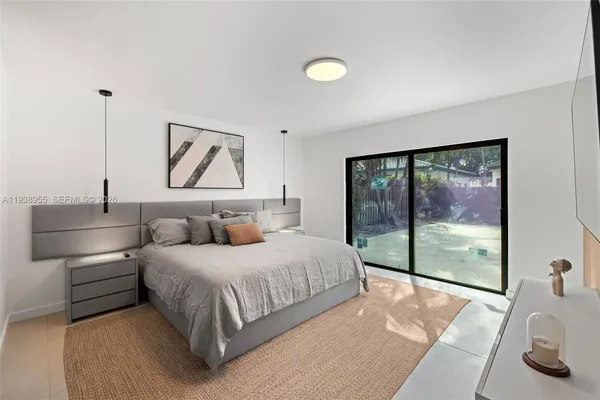a bedroom with a large bed and a large window