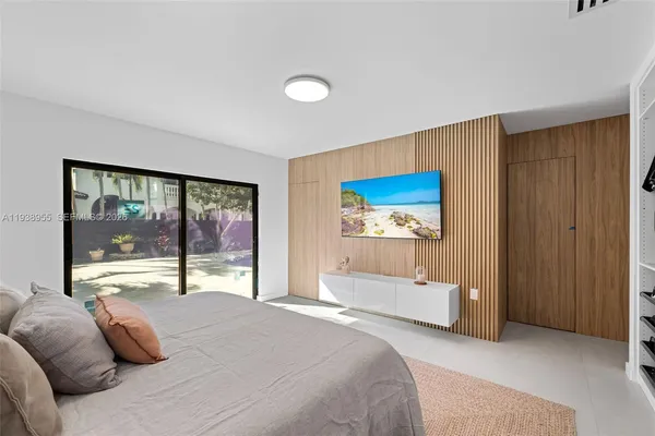 a bedroom with a large bed and a balcony view