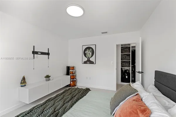 a bedroom with a bed and a chandelier