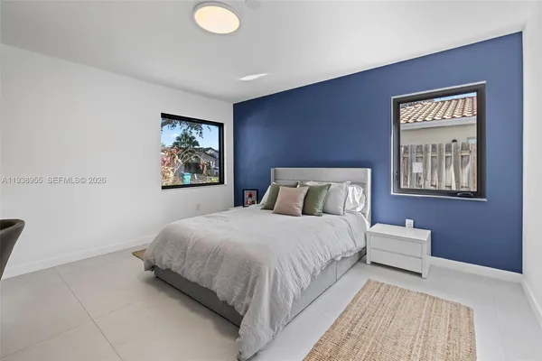 a bedroom with bed and night stand