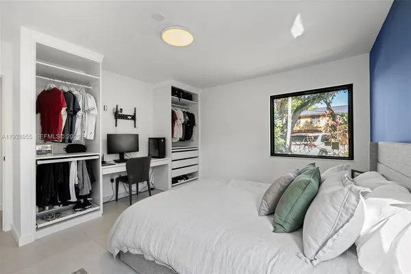 a bedroom with a bed and a painting on the wall