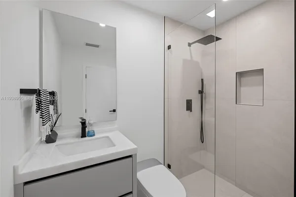 a bathroom with a sink toilet and shower