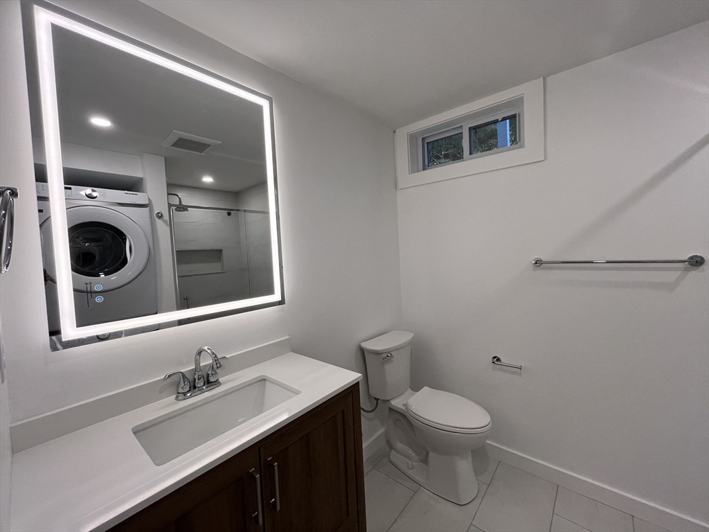 76 Sippewissett Road Falmouth, MA 02540 - Photo 22 of 28 a bathroom with a toilet a sink and mirror
