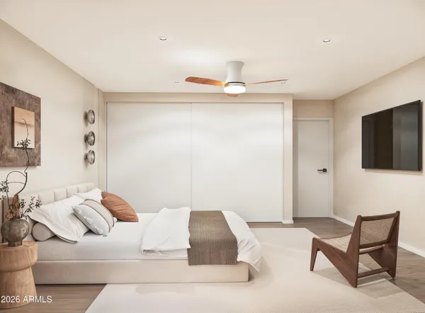 a bedroom with a bed and a television