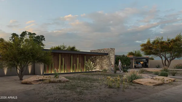 a view of a barn with big yard and a large tree