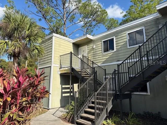 a view of front door of house with stairs