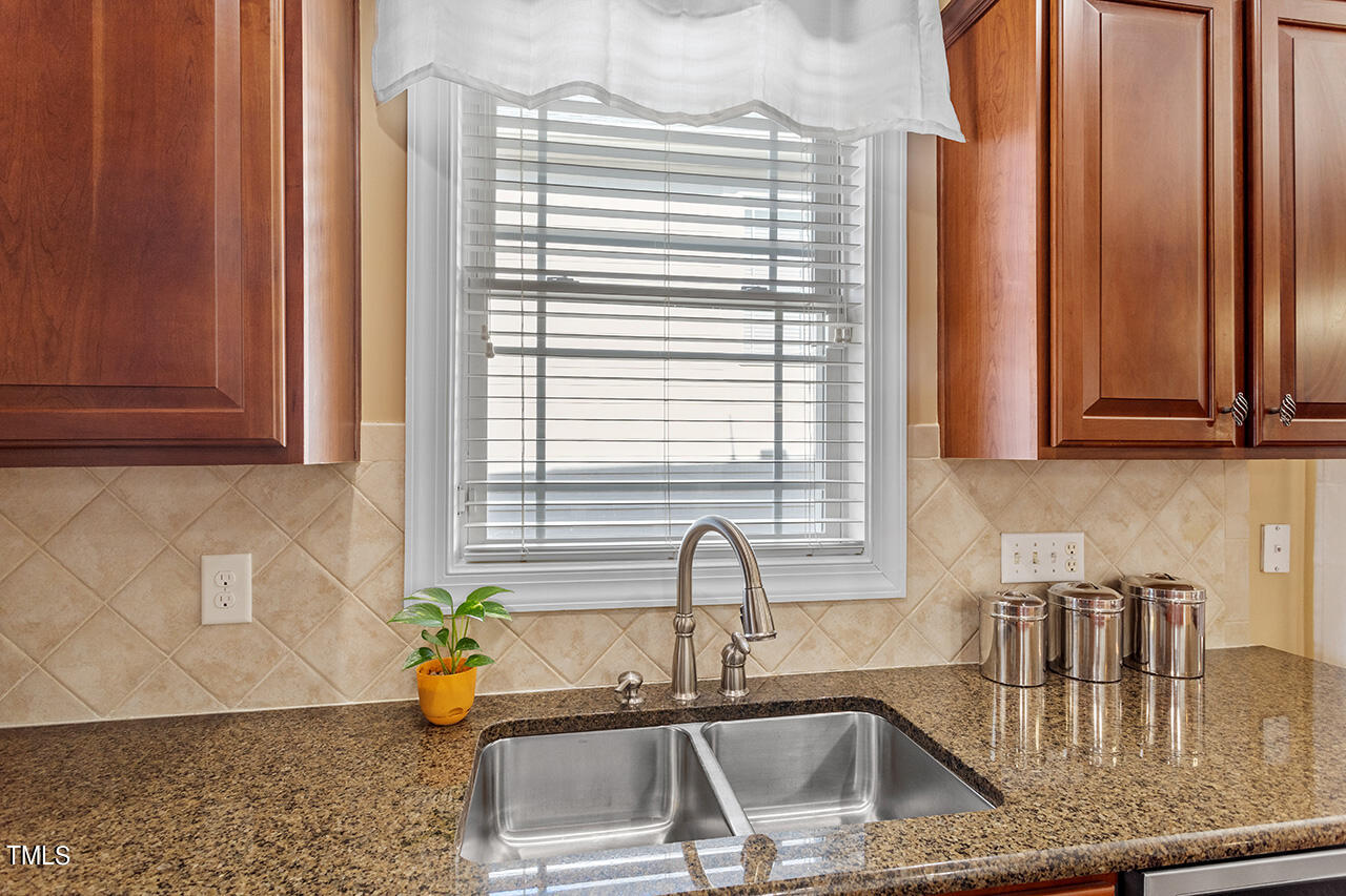 102 Juliet Circle Cary, NC 27513 - Photo 20 of 42 a kitchen with stainless steel appliances a sink a counter and cabinets