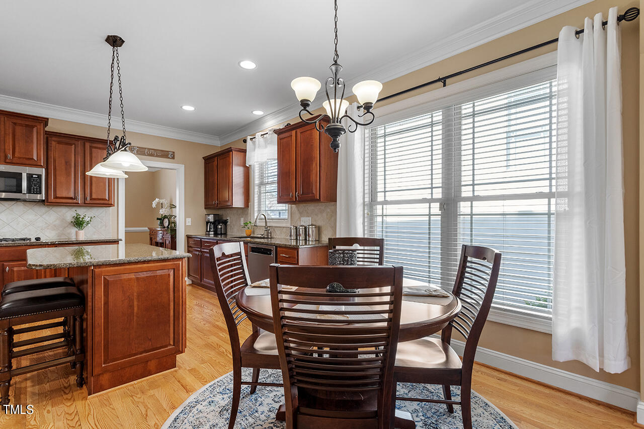 102 Juliet Circle Cary, NC 27513 - Photo 21 of 42 a view of a dining room with furniture window and wooden floor