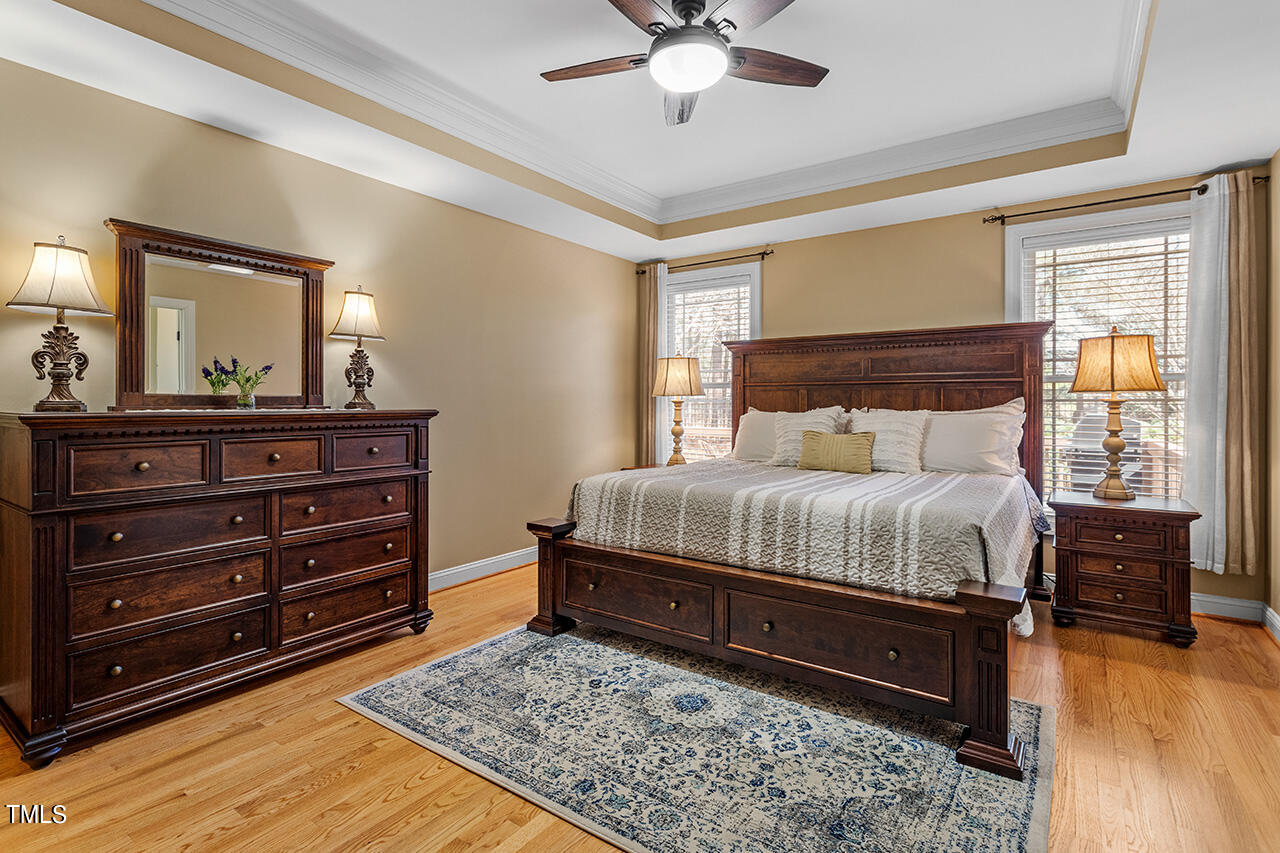 102 Juliet Circle Cary, NC 27513 - Photo 23 of 42 a bedroom with a bed and wooden floor