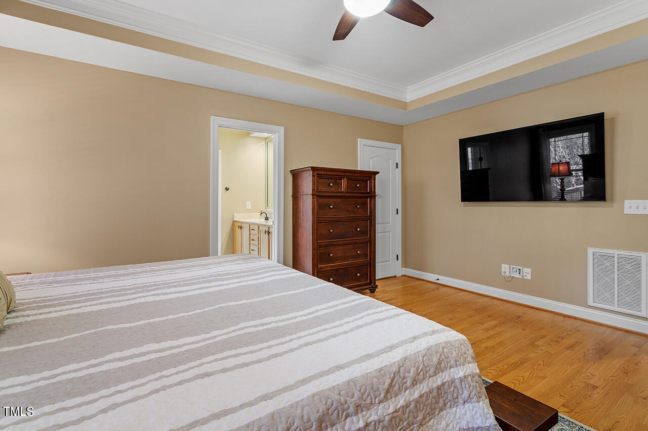 102 Juliet Circle Cary, NC 27513 - Photo 24 of 42 a bedroom with a bed and a flat screen tv