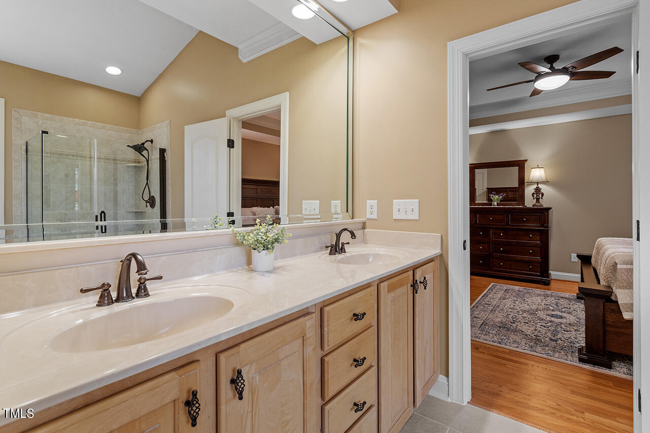 102 Juliet Circle Cary, NC 27513 - Photo 25 of 42 a bathroom with a double vanity sink and a mirror
