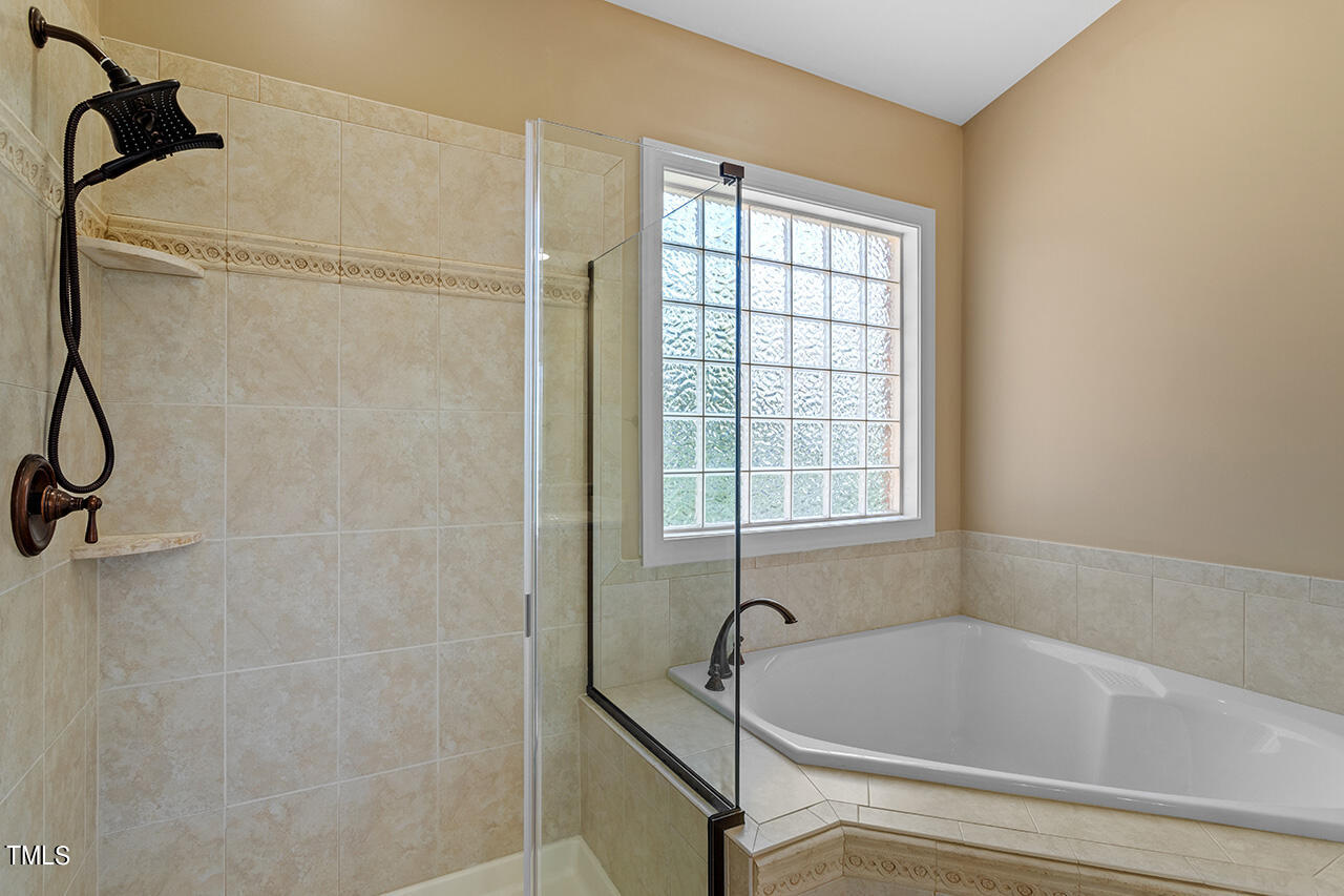 102 Juliet Circle Cary, NC 27513 - Photo 27 of 42 a bathroom with a tub and a shower