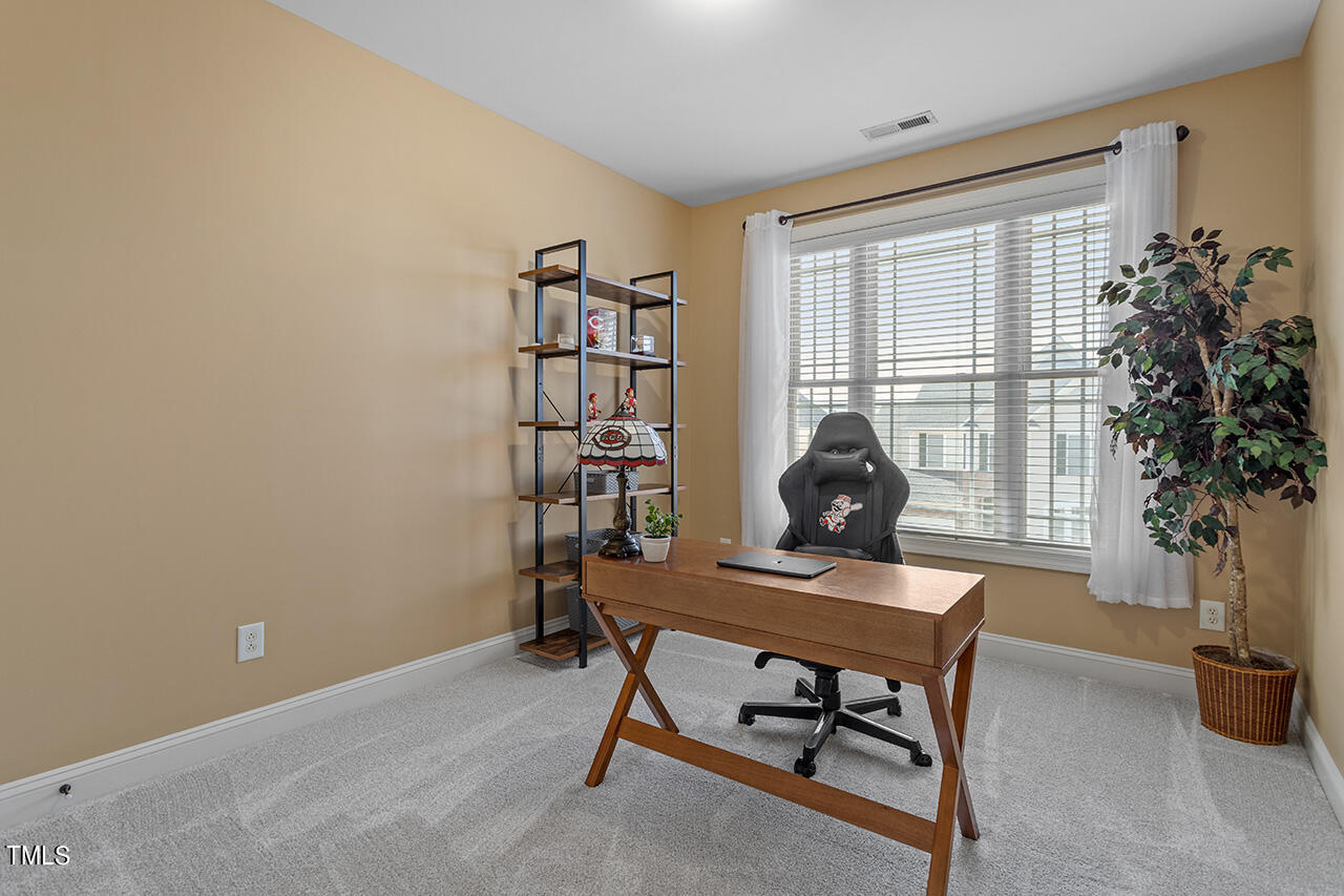 102 Juliet Circle Cary, NC 27513 - Photo 30 of 42 a workspace with furniture and a potted plant