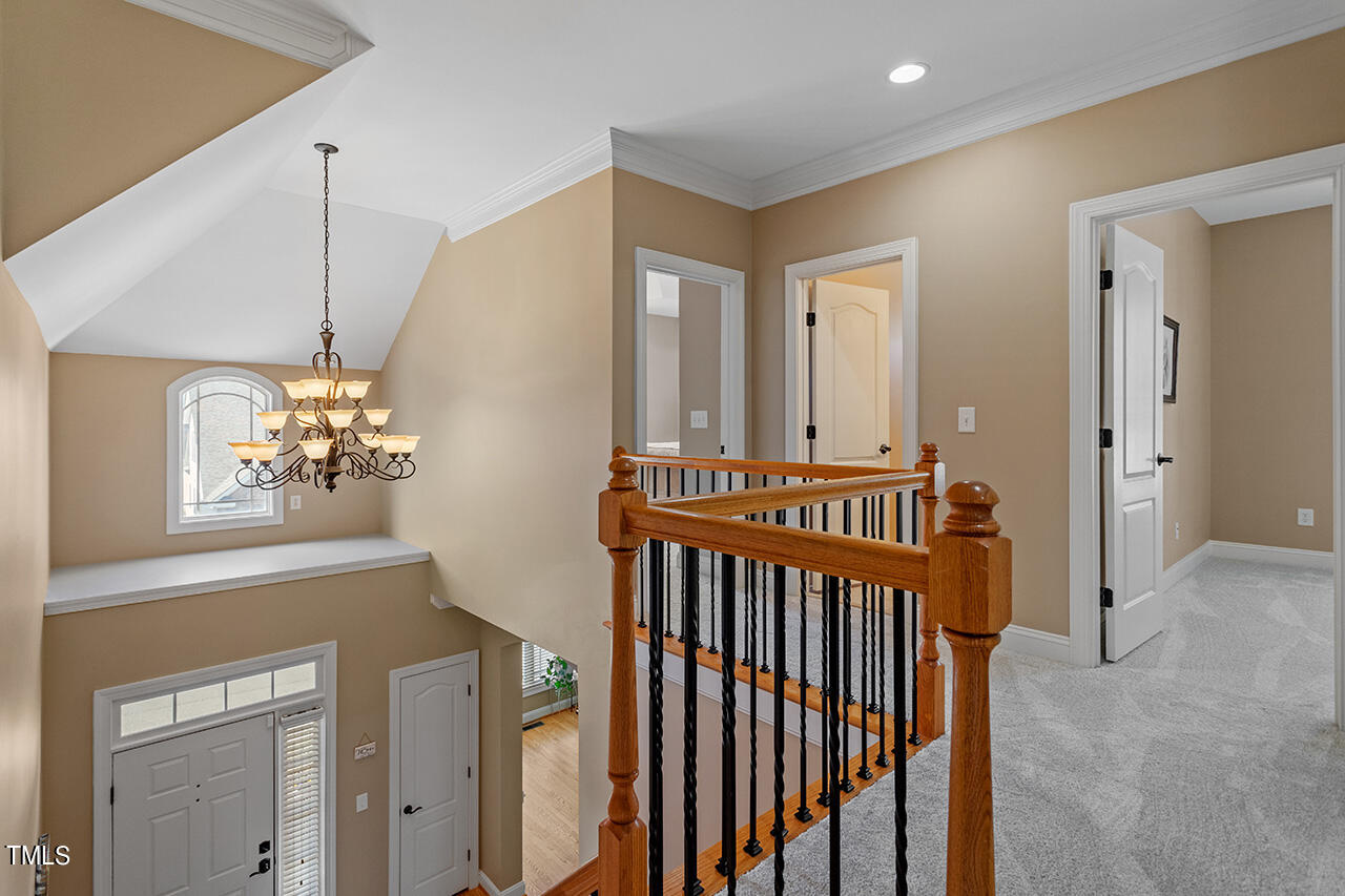102 Juliet Circle Cary, NC 27513 - Photo 36 of 42 a view of a hallway with chandelier