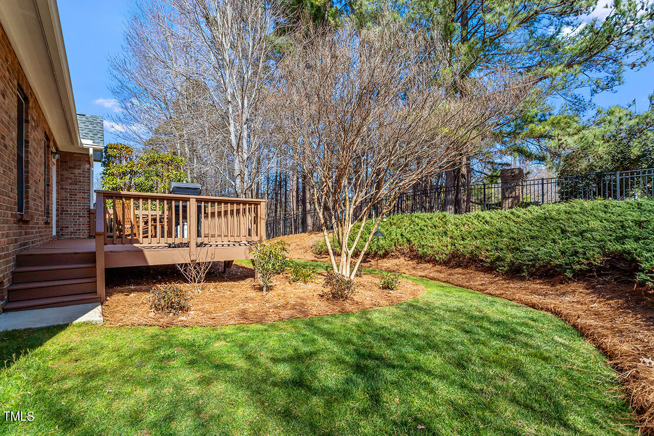102 Juliet Circle Cary, NC 27513 - Photo 38 of 42 a backyard of a house with garden and deck