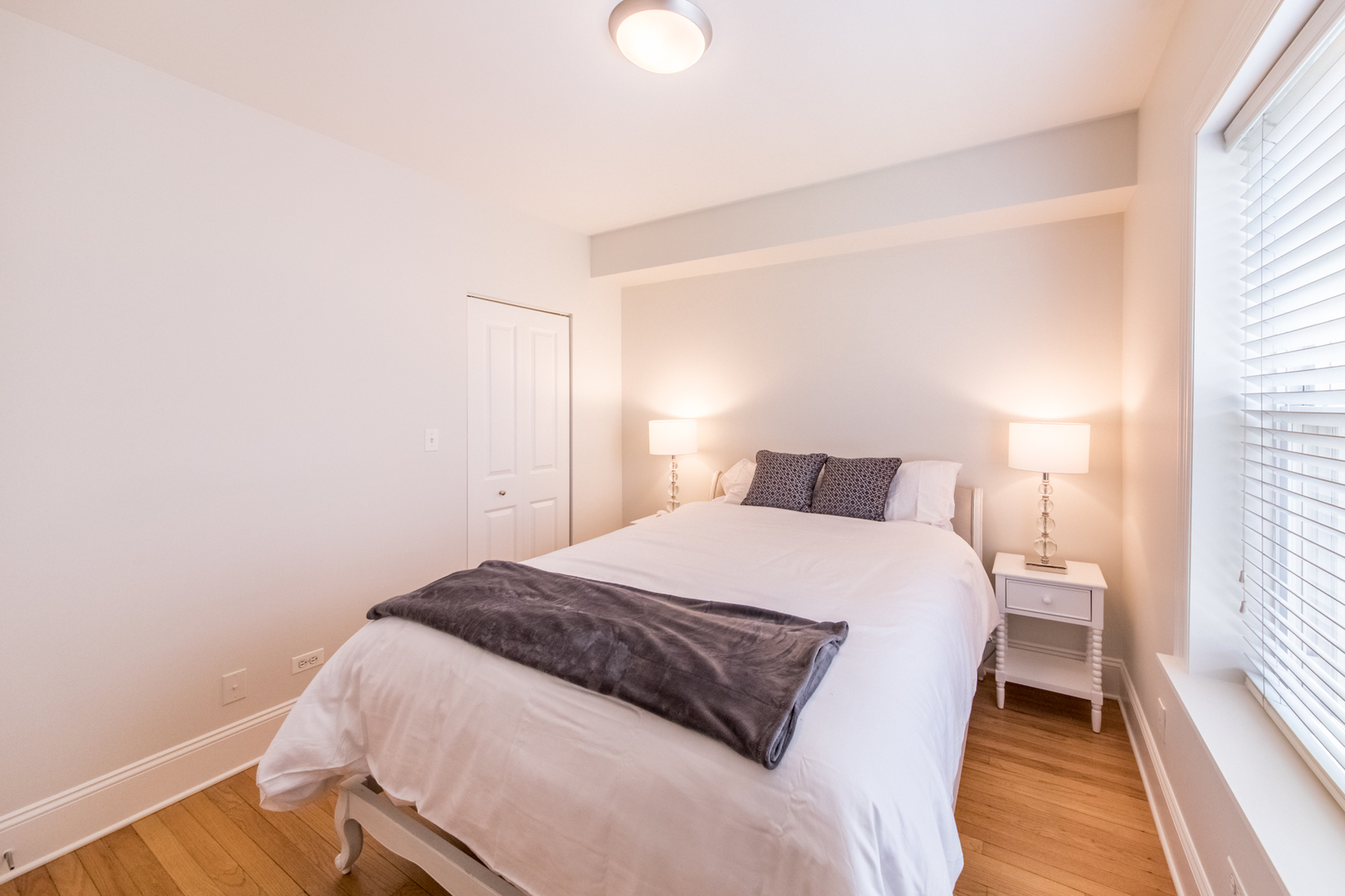 4306 North Clark Street, Unit 2 Chicago, IL 60613 - Photo 13 of 25 a bedroom with a bed and a mirror
