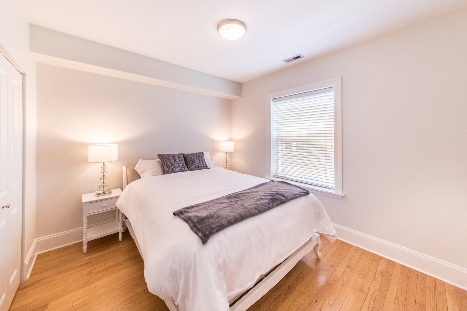4306 North Clark Street, Unit 2 Chicago, IL 60613 - Photo 14 of 25 a bedroom with a bed and wooden floor
