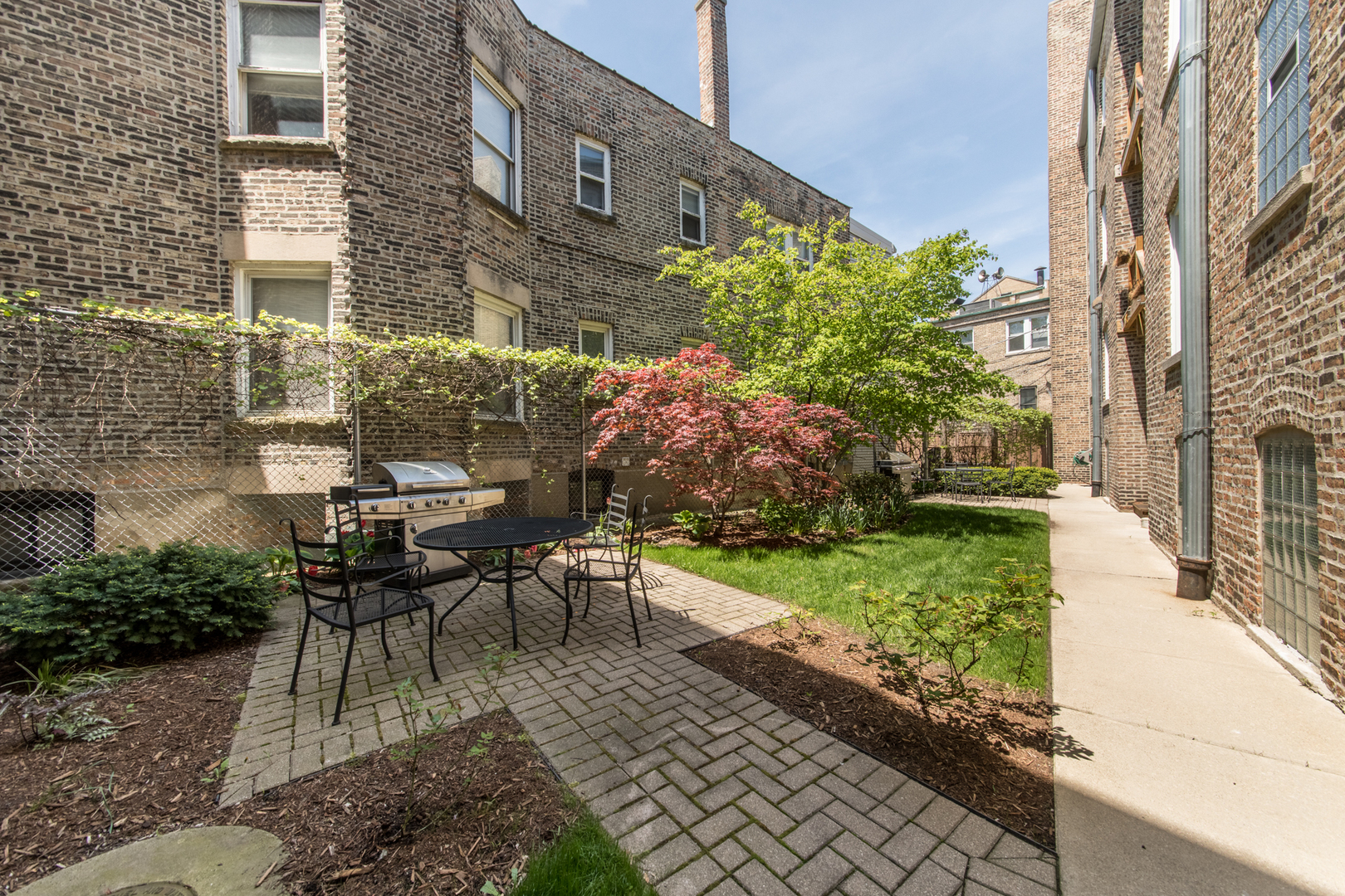4306 North Clark Street, Unit 2 Chicago, IL 60613 - Photo 21 of 25 a view of a patio with table and chairs and potted plants