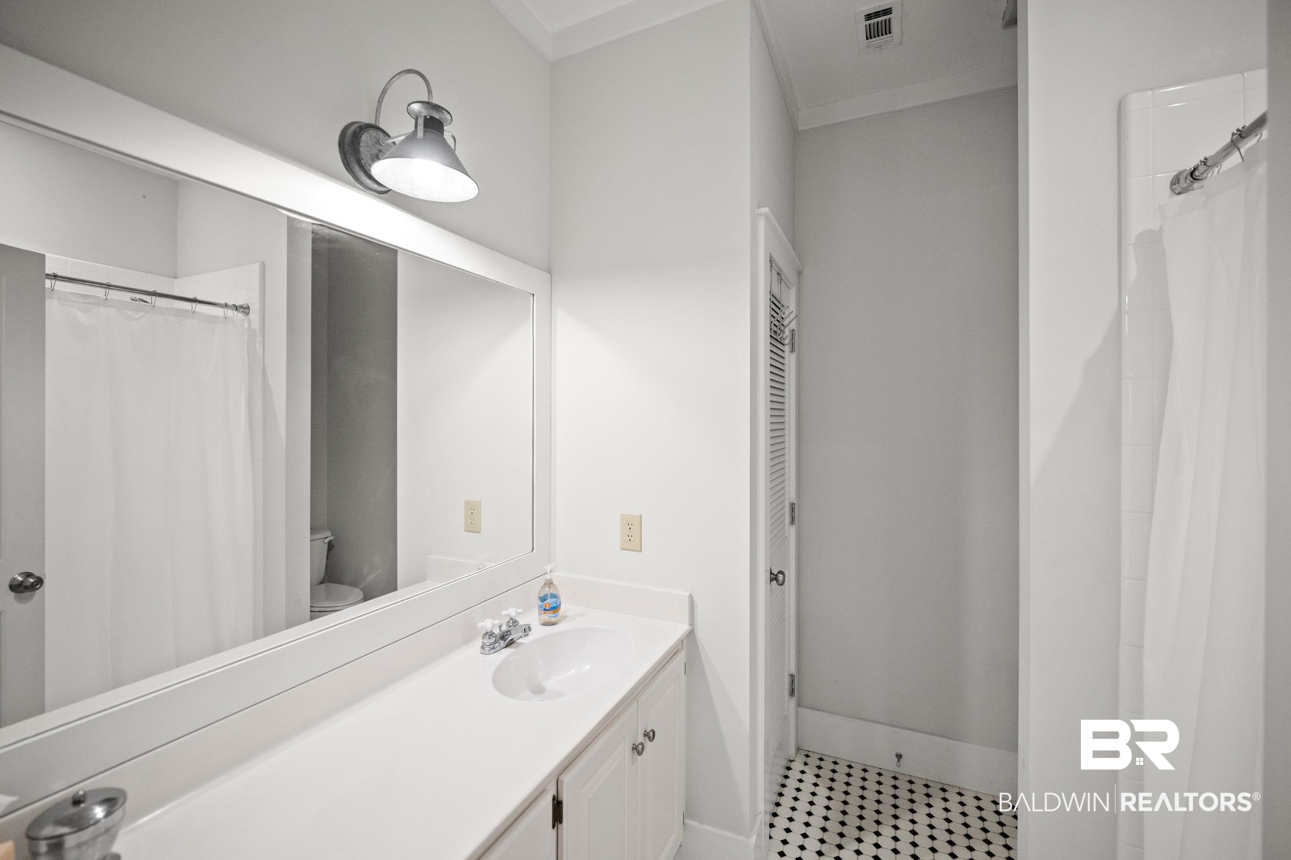 25773 Canal Road, Unit 28 Orange Beach, AL 36561 - Photo 20 of 48 Bathroom featuring a shower with shower curtain and vanity